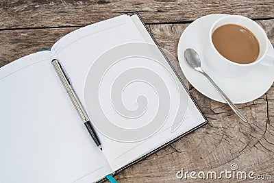 Book and cup of coffee on wood table Stock Photo