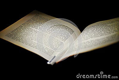 A book in a dark corner with light on it Editorial Stock Photo