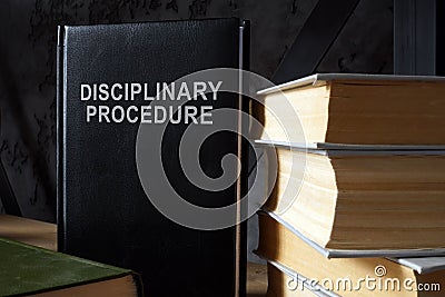 The book disciplinary procedure is on the shelf. Stock Photo