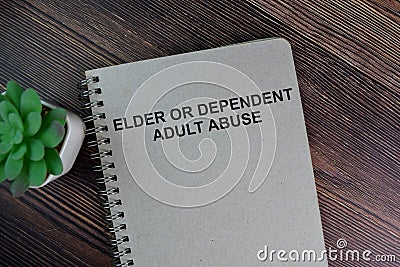 The book of Elder or Dependent Adult Abuse isolated on Wooden Table Stock Photo