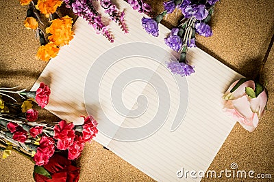 Book and flowers on wooden table Stock Photo