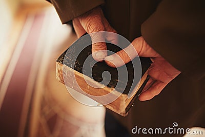 A book in the hands of an old man. little bible Stock Photo