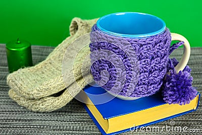 Book, knitted socks and a mug Stock Photo