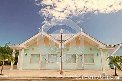 Book now pay later. Houses little cute apartments tropic island with palm trees on sunny summer day. Holiday houses Stock Photo