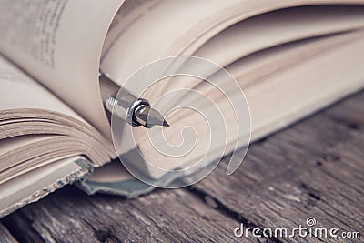 Book and pen - vintage style Stock Photo