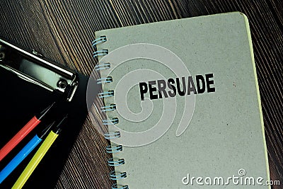 The Book of Persuade isolated on wooden table Stock Photo