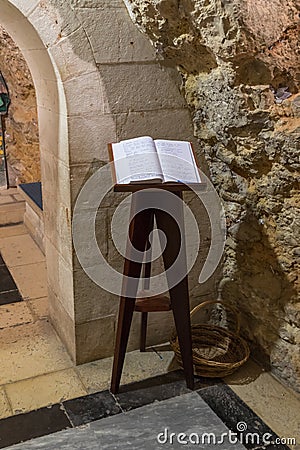 The book with reviews of visitors lies on the stand in the Church of Saint Anne near Pools of Bethesda in the old city of Jerusale Editorial Stock Photo