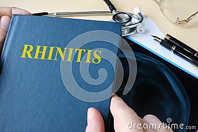 Book about Rhinitis on a desk. Stock Photo