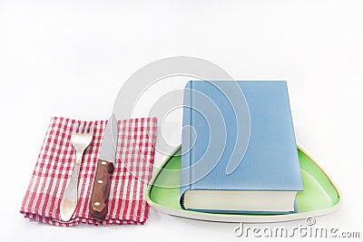 Book served on the plate with fork and knife Stock Photo