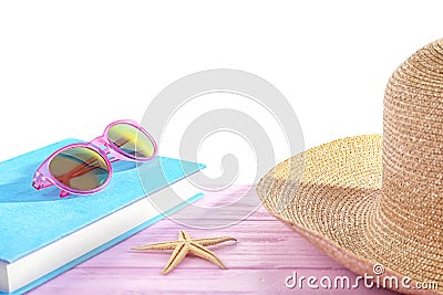 Book, sunglasses and hat on pink table Stock Photo