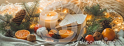 Book and Tangerines in a winter composition, Christmas trees, candles, cones, cotton, cinnamon. Symbol of New Year and Christmas Stock Photo