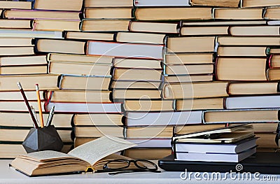 Book, textbook and glasses in library, stack piles of literature text archive, bookshelves in school study class room background f Stock Photo