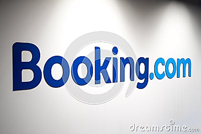 Booking.com logo on a white wall of an office Editorial Stock Photo