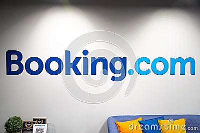 Booking.com logo on a white wall of an office Editorial Stock Photo