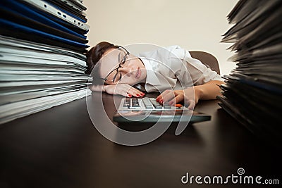 Bookkeeper asleep against big stacks of documents Stock Photo