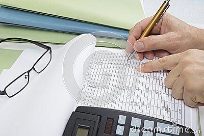 Bookkeeper or financial inspector making report, calculating or checking balance. Audit concept. Stock Photo