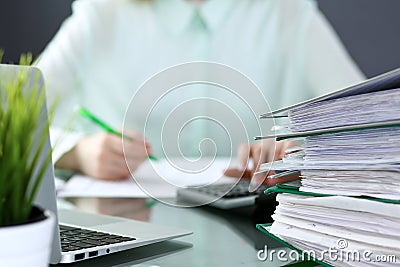 Bookkeeper or financial inspector making report, calculating or checking balance. Binders with papers closeup. Audit an Stock Photo