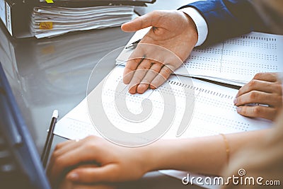 Bookkeeper or financial inspector and secretary making report, calculating or checking balance. Internal Revenue Service Stock Photo