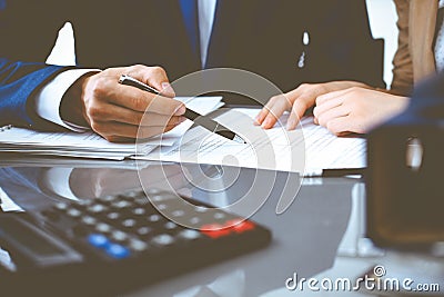 Bookkeeper or financial inspector and secretary making report, calculating or checking balance. Internal Revenue Service Stock Photo