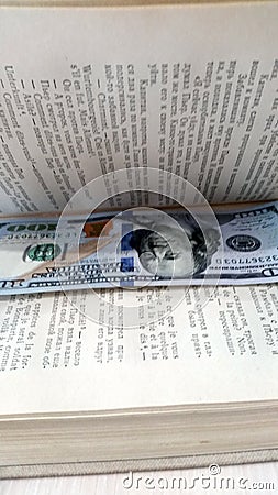 A bookmark, a stash in a book.A hundred-dollar bill Editorial Stock Photo