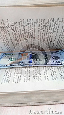 A bookmark, a stash in a book.A hundred-dollar bill Editorial Stock Photo