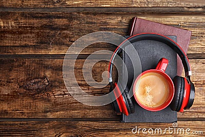 Books, coffee and headphones on wooden table. Space for text Stock Photo