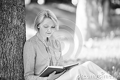 Books every girl should read. Girl concentrated sit park read book nature background. Reading inspiring books. Female Stock Photo