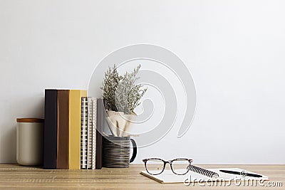 Books, notebook, coffee and flower over the wooden table. Stock Photo