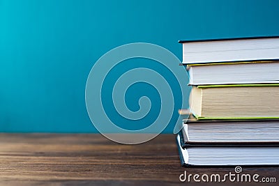 Books on table in front of chalk board Stock Photo