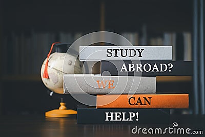 Books with words 'Study Abroad We Can Help Concept of global business study abroad educational, Back to School. Education in Stock Photo