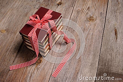 Books wrapped with color ribbon, on wooden table Stock Photo