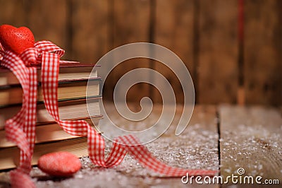 Books wrapped with color ribbon, on wooden table Stock Photo