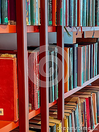 Bookshelves with various books in the city library Editorial Stock Photo