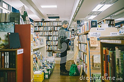 Bookstore concept, man reading book in bookstores Editorial Stock Photo