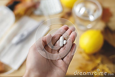 Boost immune system, coronavirus treatment. Hand with vitamin D, vitamin C and zinc pills Stock Photo