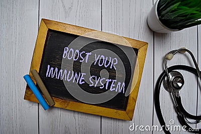 Boost Your Immune System write on a chalkboard isolated on office desk Stock Photo