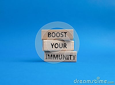 Boost your immunity symbol. Concept word Boost your immunity on wooden blocks. Beautiful blue background. Helthcare and Boost your Stock Photo