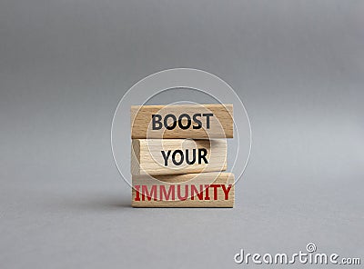 Boost your immunity symbol. Concept word Boost your immunity on wooden blocks. Beautiful grey background. Helthcare and Boost your Stock Photo