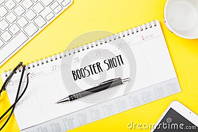 Booster shot, corona vaccination appointment in agenda on desk Stock Photo