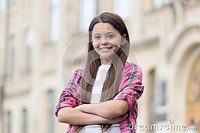 Boosting her girls confidence. Confident child keep arms crossed outdoors. Confident look of fashion girl. Casual style Stock Photo