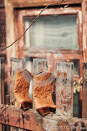 Boots on the fence Stock Photo