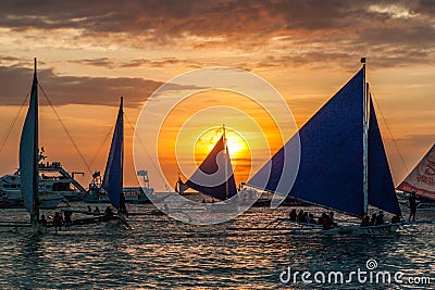 BORACAY, PHILIPPINES - FEBRUARY 1, 2018: Sunset behind Bangkas (paraw), double-outrigger boats, Boracay island Editorial Stock Photo