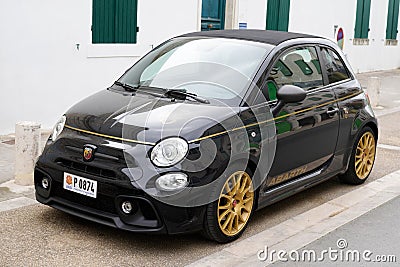 Abarth fiat car 500 golden black race vehicle sport automobile parked in street Editorial Stock Photo