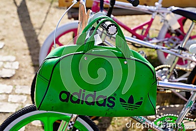 Adidas logo sign and brand text on old ancient green sport bag retro on bmx bicycle Editorial Stock Photo