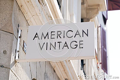 American Vintage text sign and logo on wall boutique of French fashion label like us Editorial Stock Photo