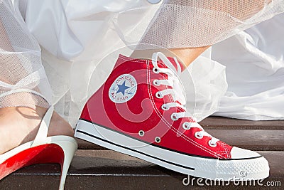 Bordeaux , Aquitaine / France - 11 07 2019 : Bride feet Wedding Dress and red Sneakers converse all star chuck taylor Editorial Stock Photo