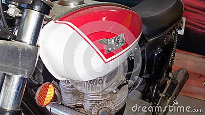 BSA logo and sign on ancient sixties motorbike red white fuel tank of retro vintage Editorial Stock Photo