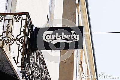 Carlsberg text and sign logo of beer front of bar restaurant in french street for pub Editorial Stock Photo