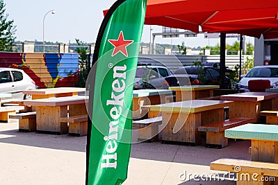 Heineken sign text and logo on green flag for dutch brewing company Editorial Stock Photo