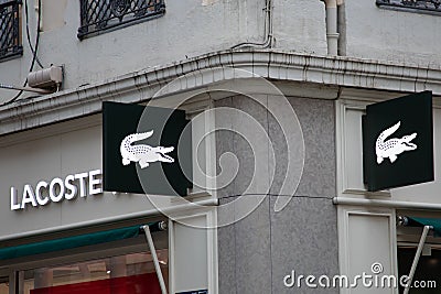 lacoste sign text and logo brand on wall facade entrance on fashion clothes Editorial Stock Photo